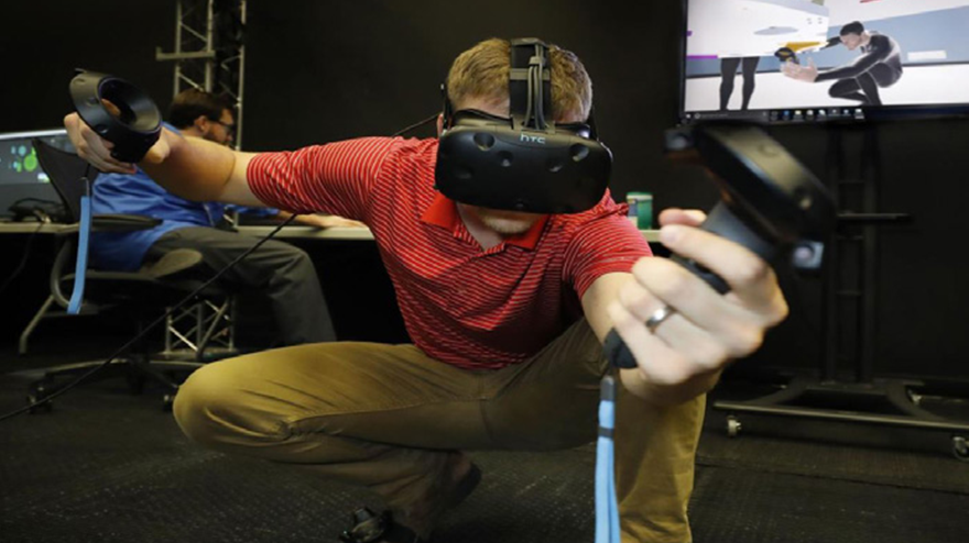 A person using a VR headset, crouching on the floor