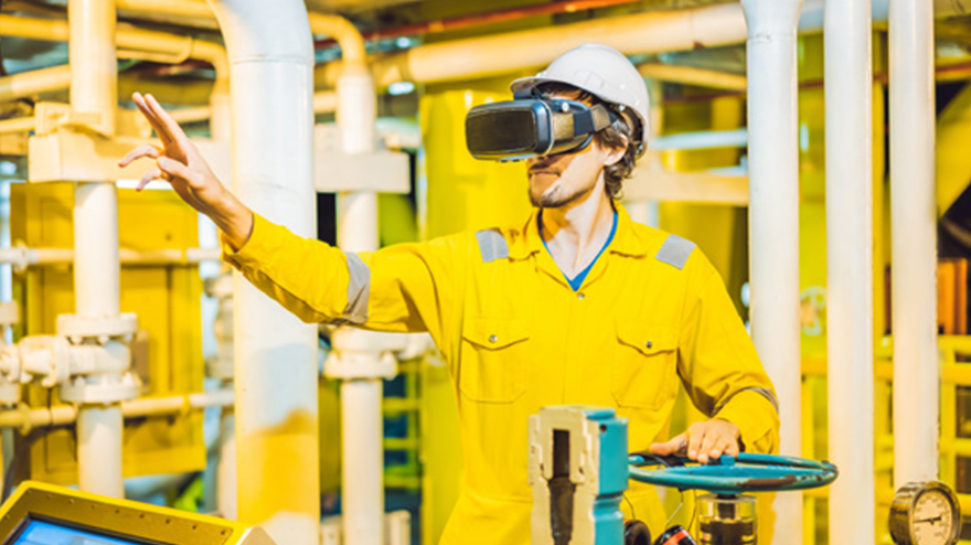 Man at an industrial worksite wearing VR headset