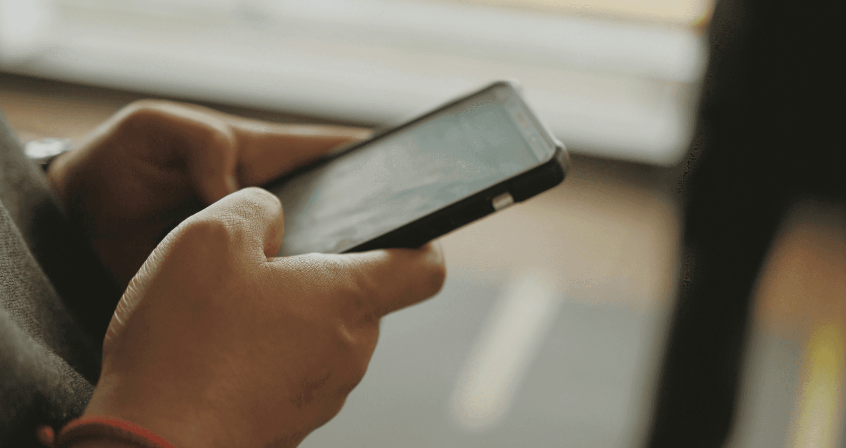 someone is tapping his cellphone