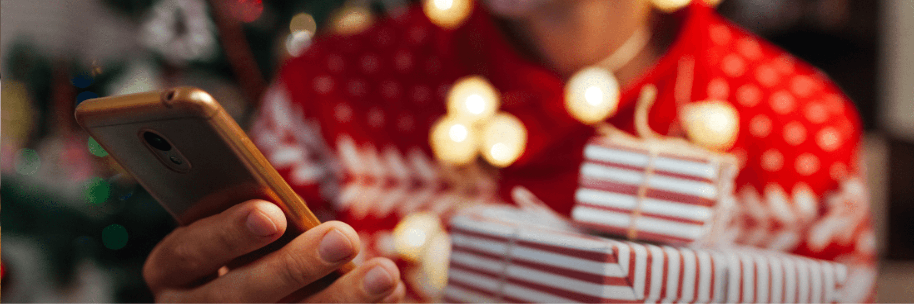 Person holding a mobile phone, dressed for the holidays