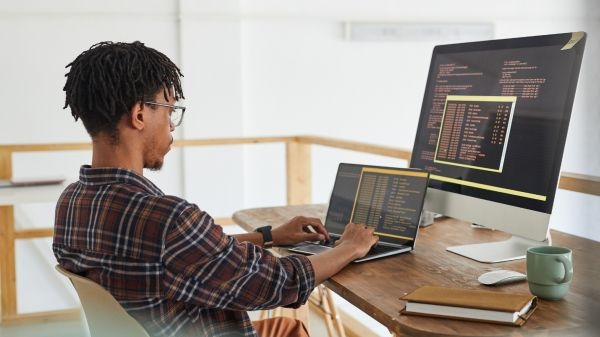 Man coding on laptop