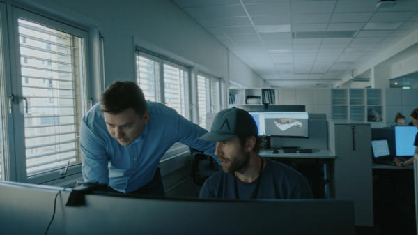 Two men working at a computer