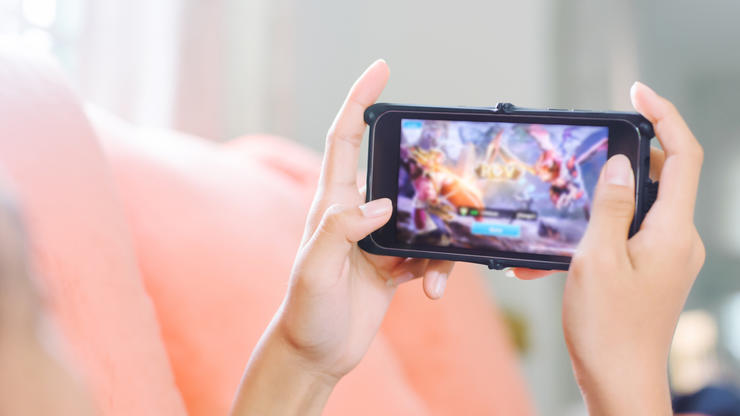 Person holding a mobile device playing a game made from Unity